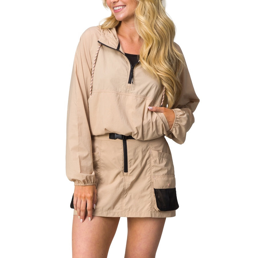 Woman wearing beige Anorak Hoodie with front pocket and black drawstring, styled for beach comfort and active lifestyle