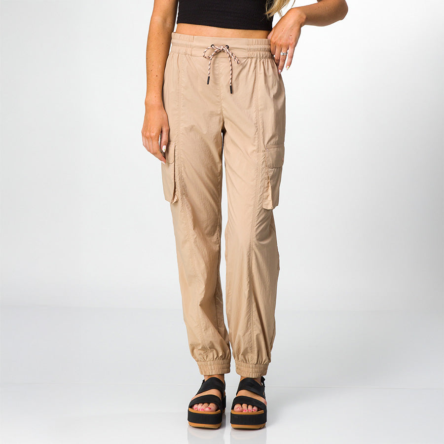 Front view of women's Cargo Jogger Pant in beige, paired with black platform sandals featuring soft-rebound cushioning.