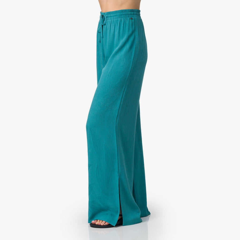 Ollie Pant in teal women's apparel side view showing wide leg cut with split hem, beach inspired comfort design.