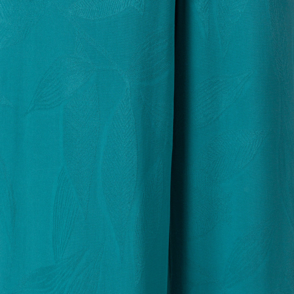 Ollie Tank close-up of teal fabric texture with subtle surf-inspired pattern, designed for comfort and beach lifestyle.