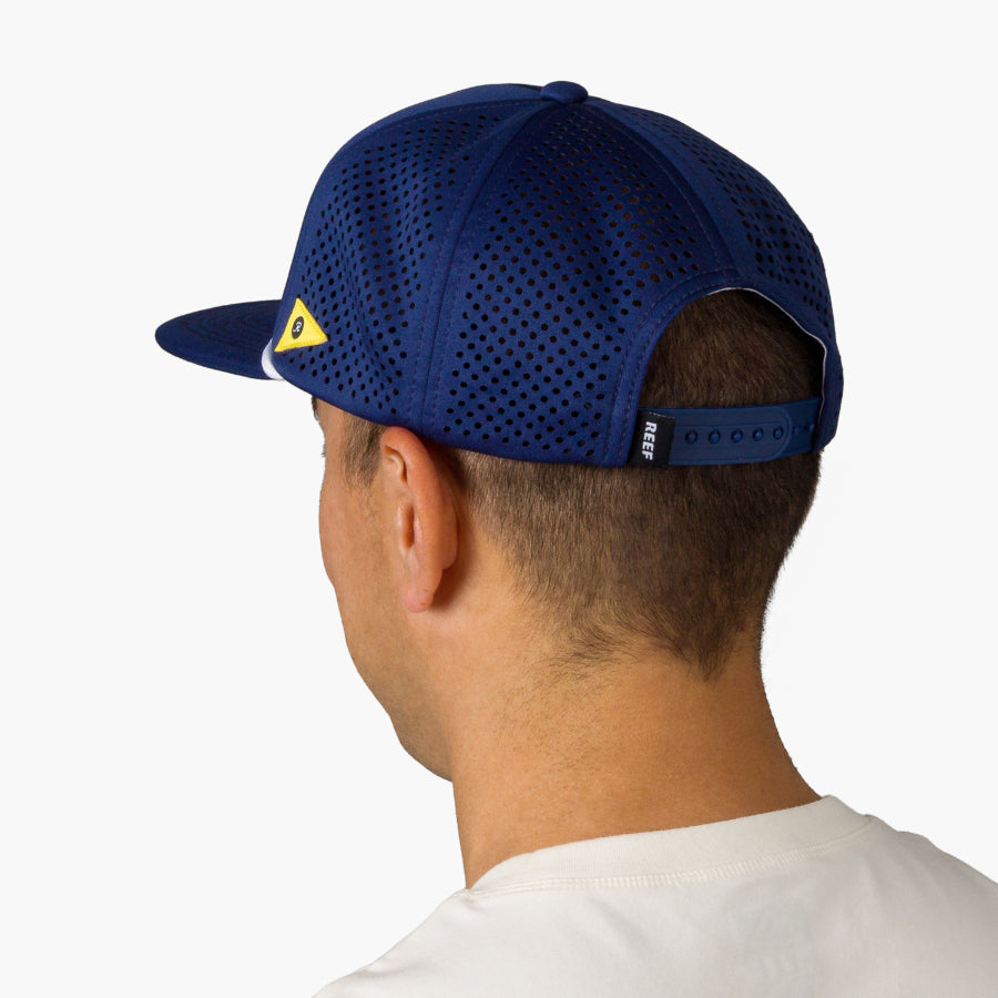 Blackball Hat on a man facing away, showing breathable perforated back panel and adjustable strap for comfort.