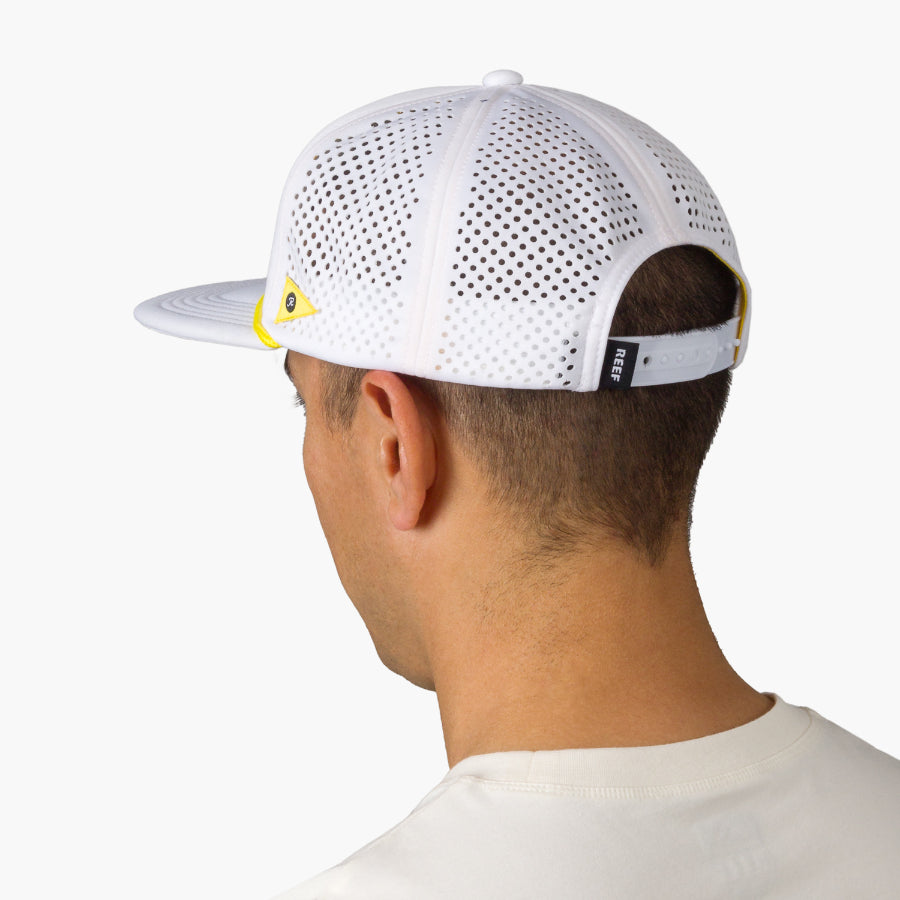 Blackball Hat worn by man, back view showing white breathable mesh with yellow accents and adjustable strap closure.