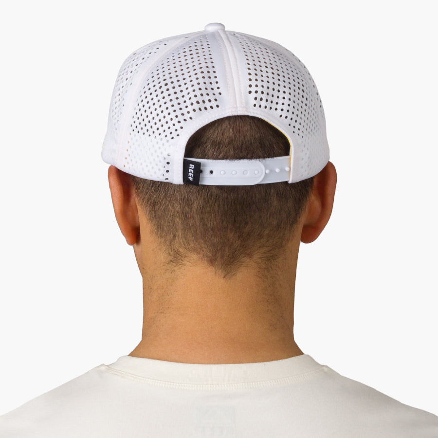 Back view of adult man wearing a white Blackball Hat with breathable mesh and adjustable strap, surf-inspired comfort.