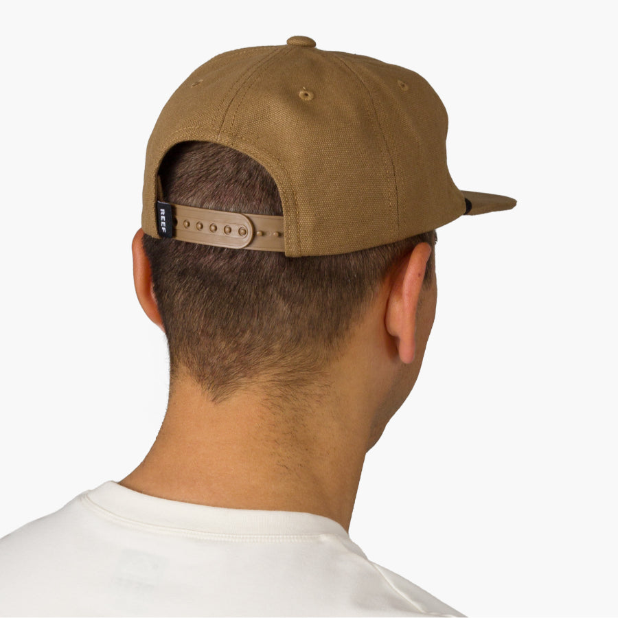 Rear view of a man wearing a brown Trapper Hat, adjustable strap visible, showcasing comfort and surf-inspired design.