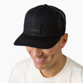 Man wearing a black Tonal Townsend Hat facing forward, surf-inspired with comfort and breathable mesh back.