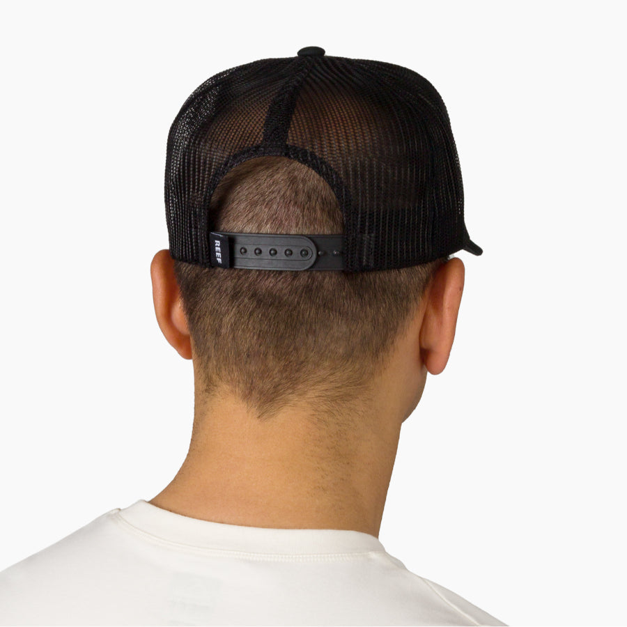 Back view of a man wearing a black Tonal Townsend Hat with adjustable strap, surf-inspired comfort and durability.