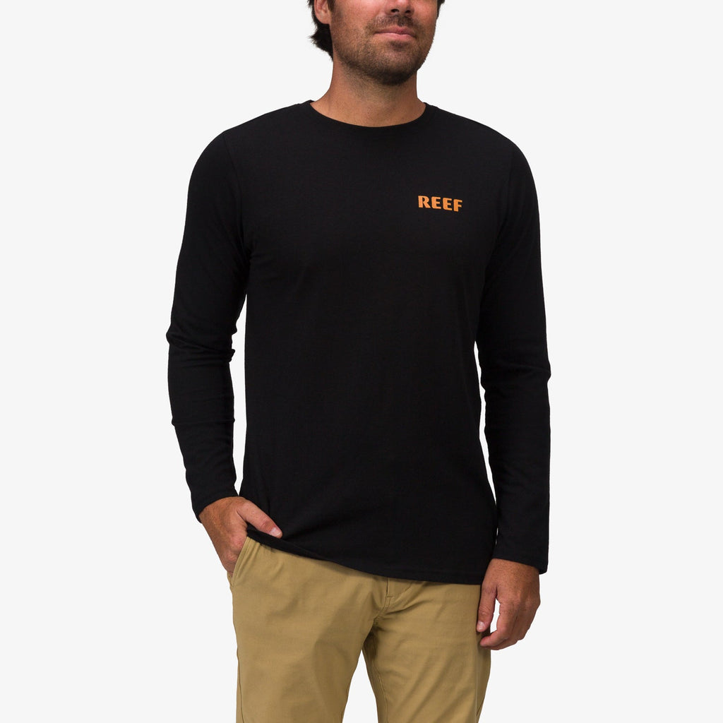 Front view of a man wearing the Wellie 24 Long Sleeve Tee in black with comfort-focused, beach-inspired design from REEF.