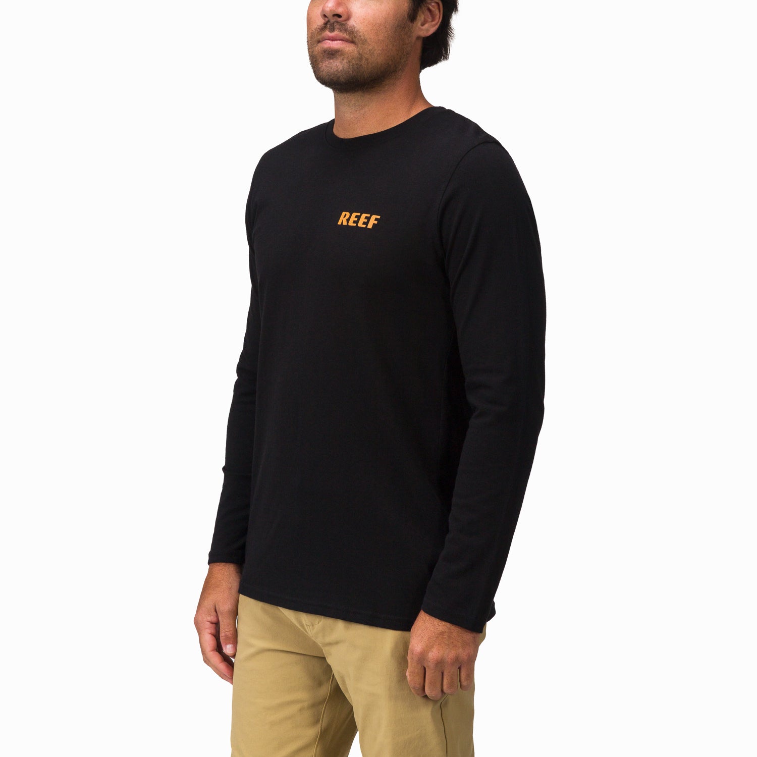 Man wearing black Wellie 24 Long Sleeve Tee facing front right, featuring reef logo on chest, beach-inspired apparel.