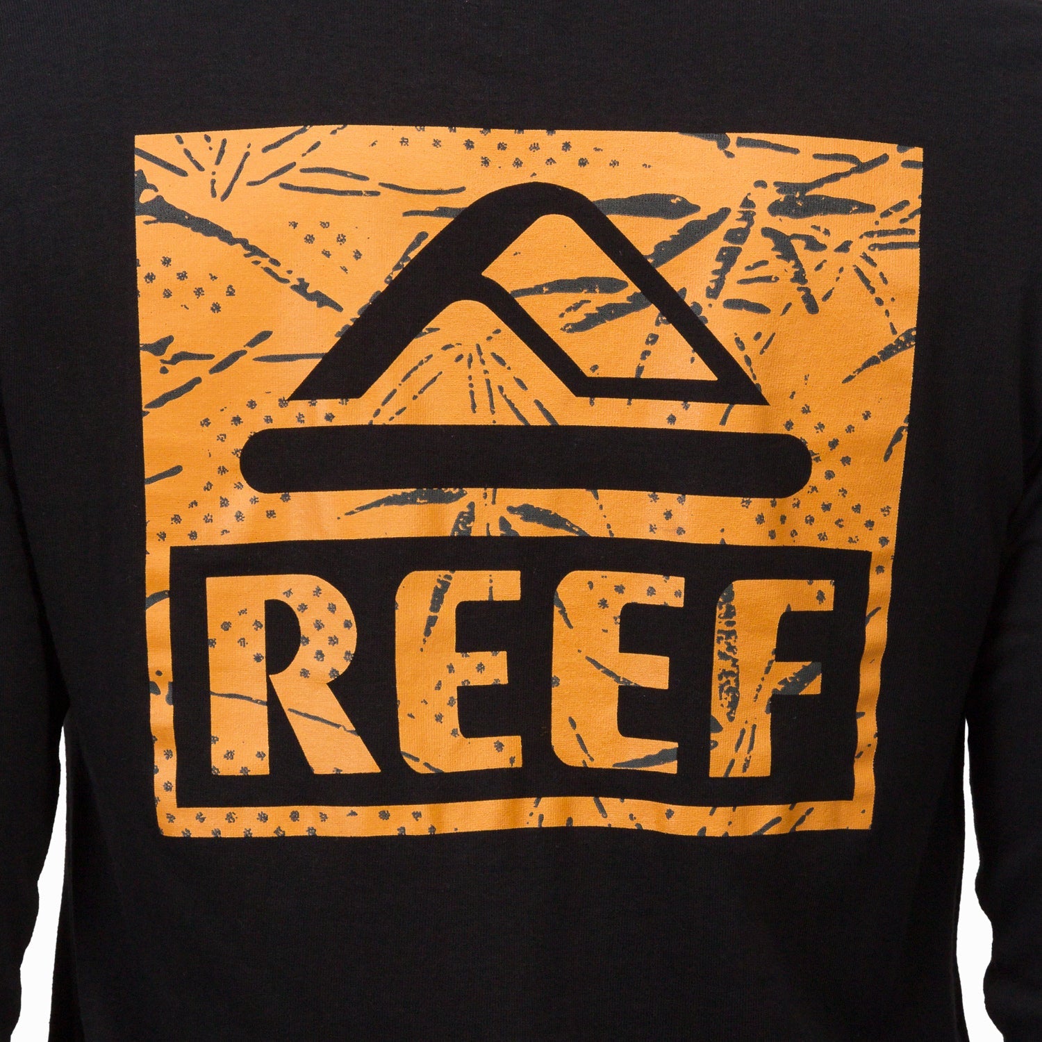 Close-up of the chest logo on the black Wellie 24 Long Sleeve Tee featuring surf-inspired design and comfort-focused fabric.