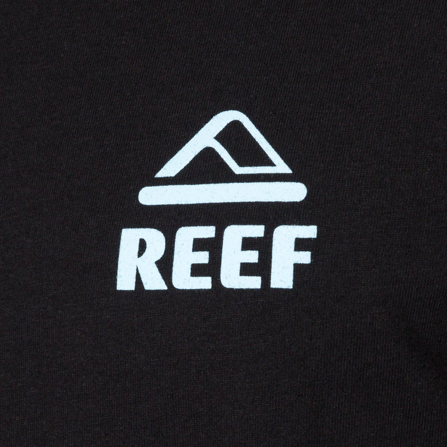 Close-up of black Strings Tee featuring white REEF logo, showcasing durable, beach-inspired apparel with comfort-focused design.