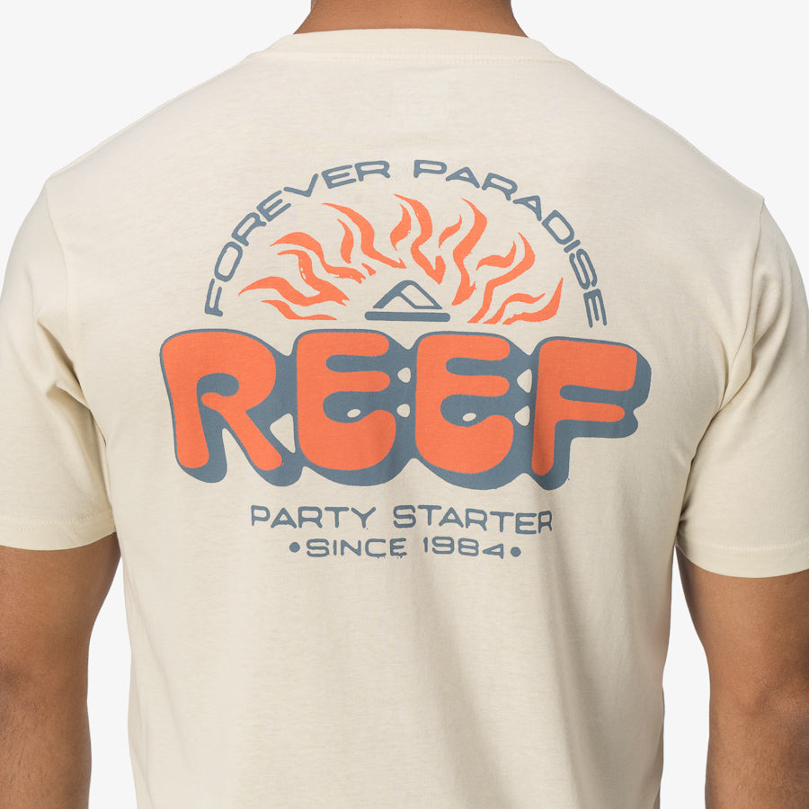 Back view of a man wearing a Quinn Tee with REEF logo and "Forever Paradise" design, beach-inspired comfort apparel