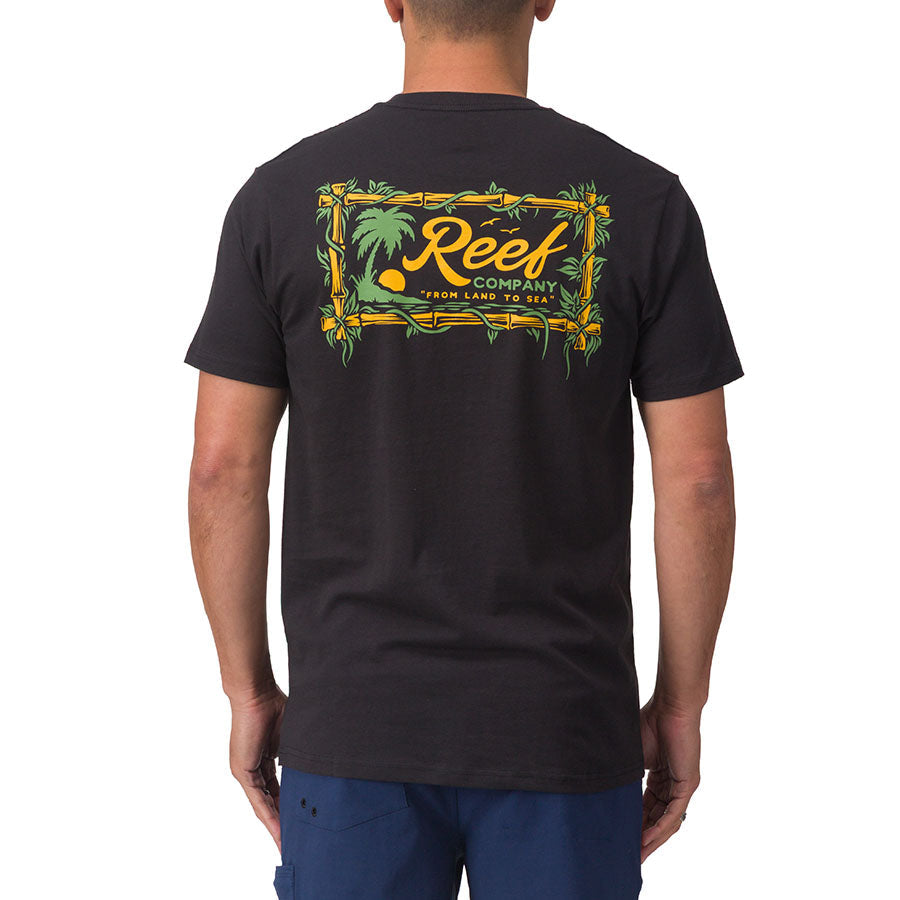 Rear view of a man wearing a black Isac Tee with colorful Reef logo graphic, surf-inspired and comfort focused design.