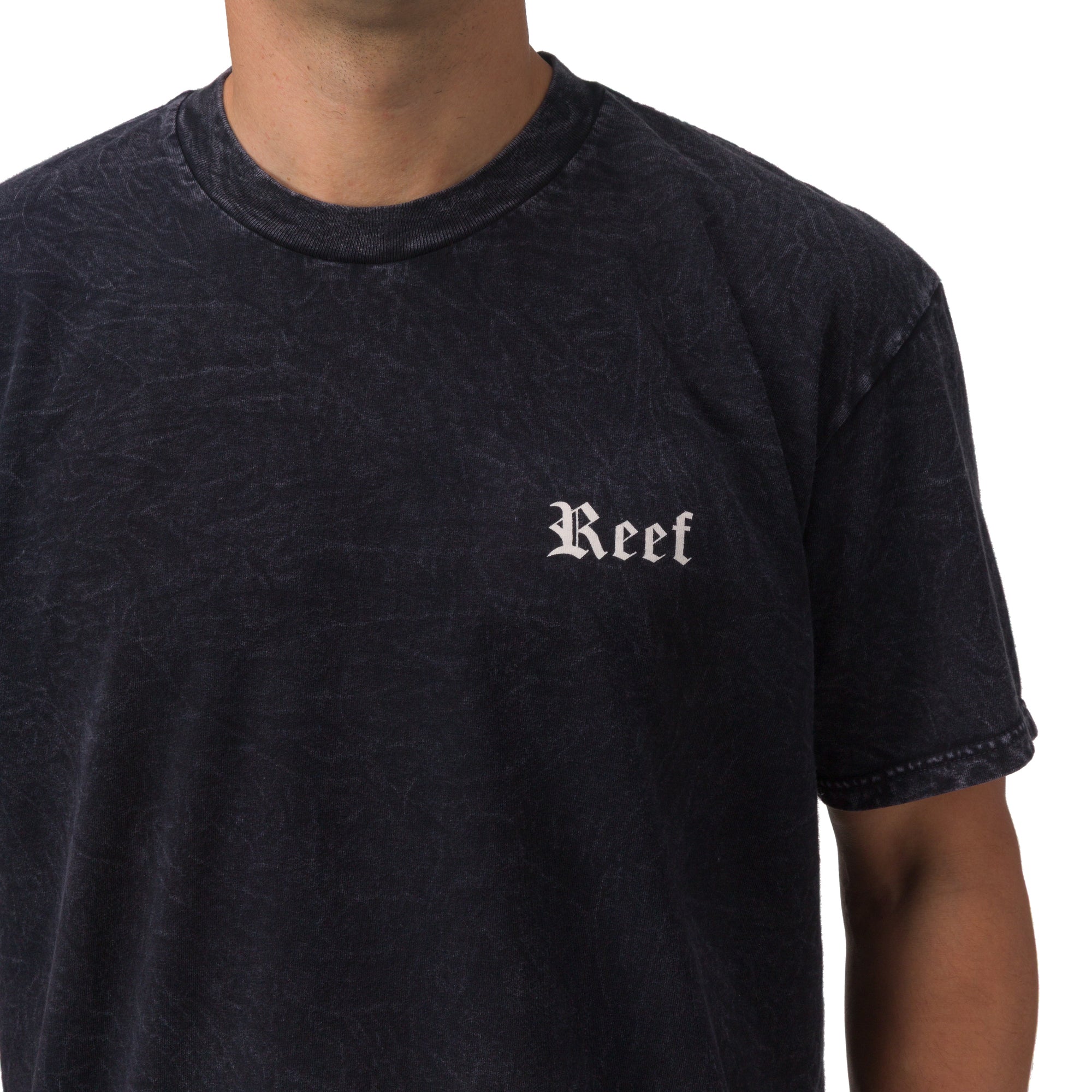 Men's Pray Tee in black with subtle textured fabric, featuring Reef logo on chest, surf-inspired casual comfort apparel.