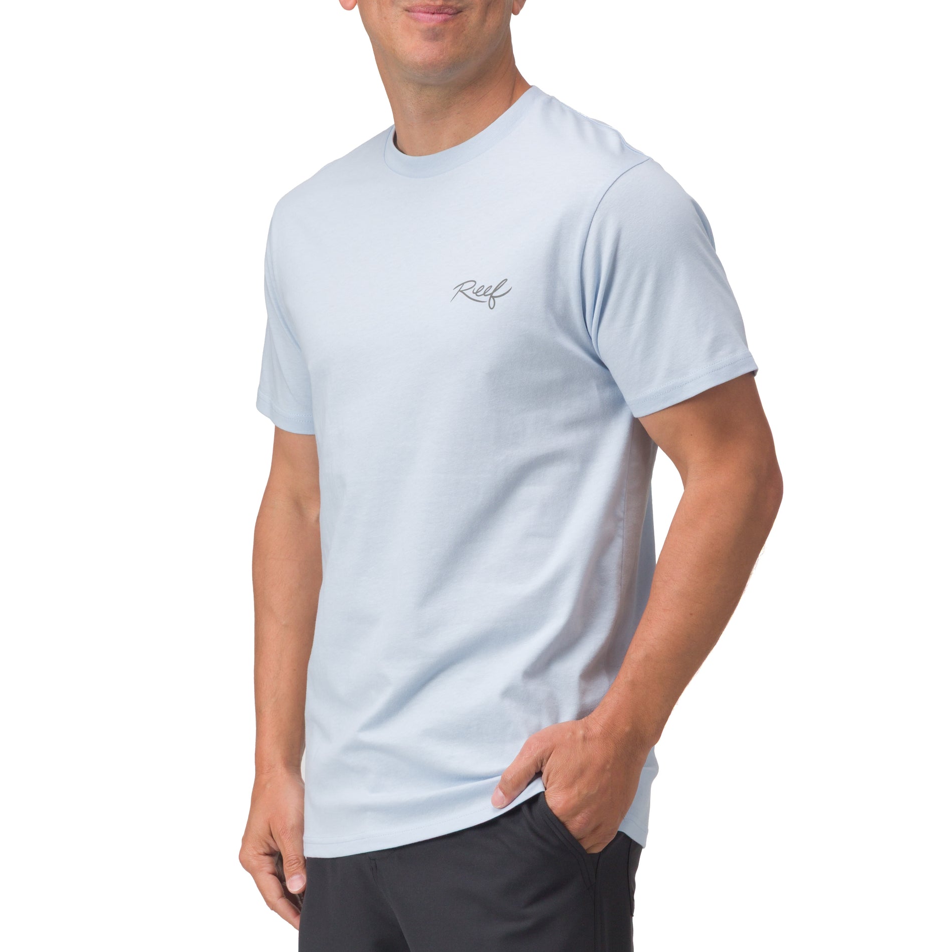 Man wearing light blue Marlinrita Tee standing with right hand in pocket, showcasing comfortable, beach-inspired apparel.