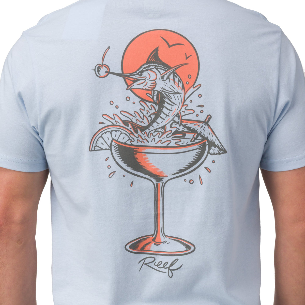 Back view of Marlinrita Tee in light blue with a surf-inspired fish cocktail graphic and Reef logo on the back.