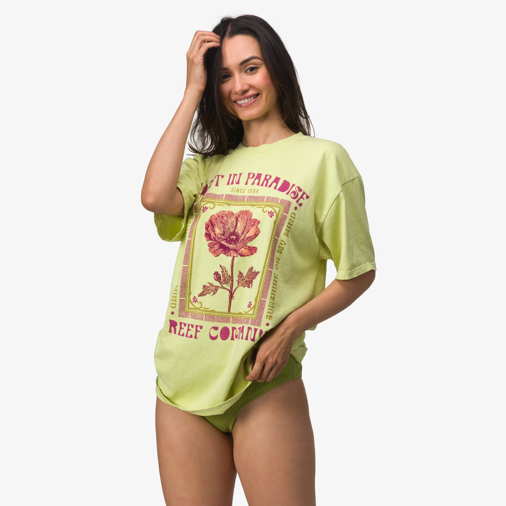 Woman wearing Lost Girls Boyfriend Crew t-shirt in light green, front view, beach-inspired comfort apparel.