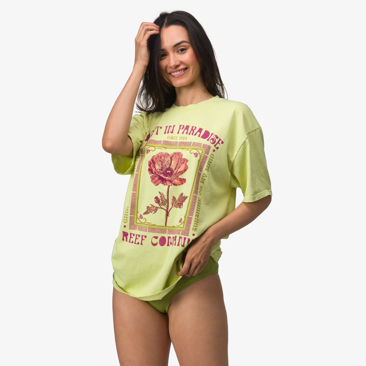 Woman wearing Lost Girls Boyfriend Crew t-shirt in light green, front view, beach-inspired comfort apparel.