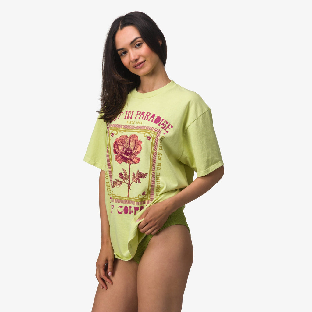 Model wearing Lost Girls Boyfriend Crew tee in light green with floral graphic, front facing, showcasing relaxed fit and soft fabric.