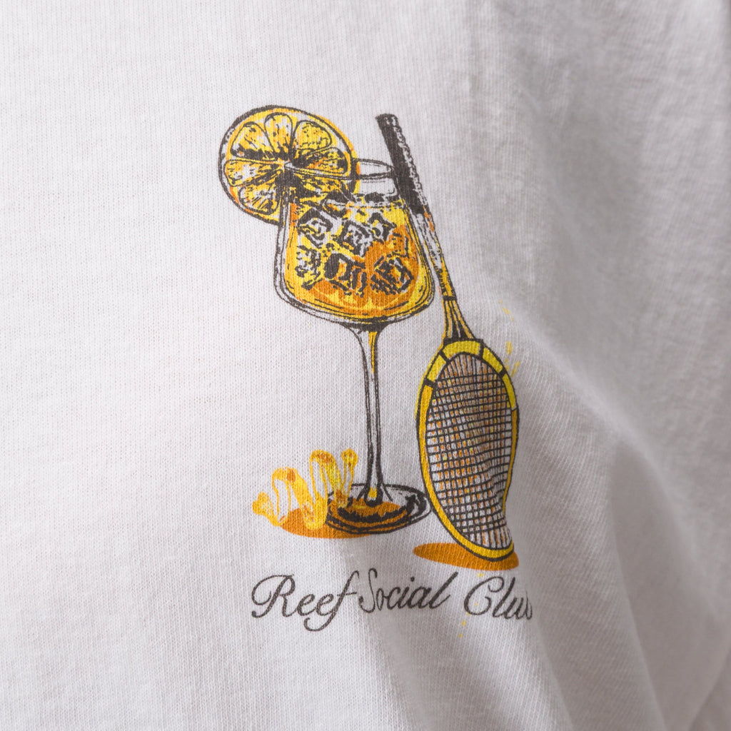 Close-up of Social Boyfriend Crew white shirt showing yellow and black tennis racket and drink graphic on chest.