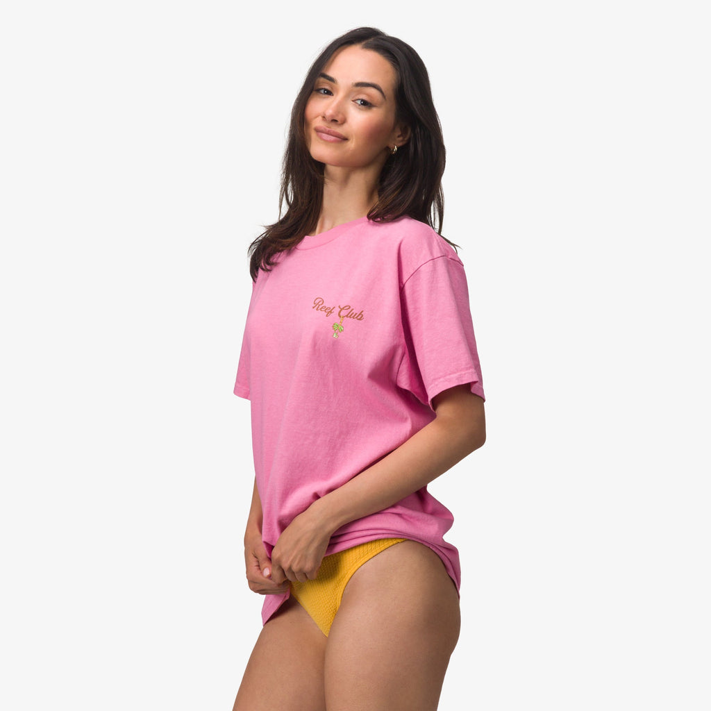 Woman wearing pink Haus Boyfriend Crew t-shirt with relaxed fit, posing with right side facing and casual expression