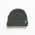 Alyx Beanie in dark green knit fabric shown flat with folded cuff and small REEF tag, designed for comfort and style.
