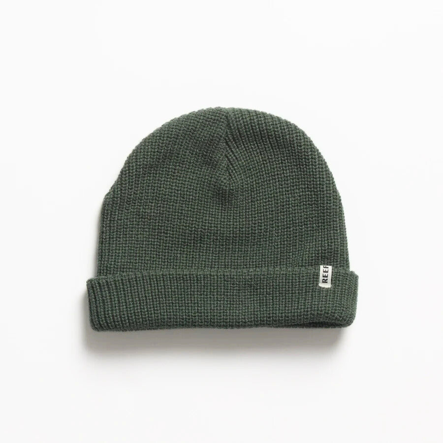 Alyx Beanie in dark green knit fabric shown flat with folded cuff and small REEF tag, designed for comfort and style.