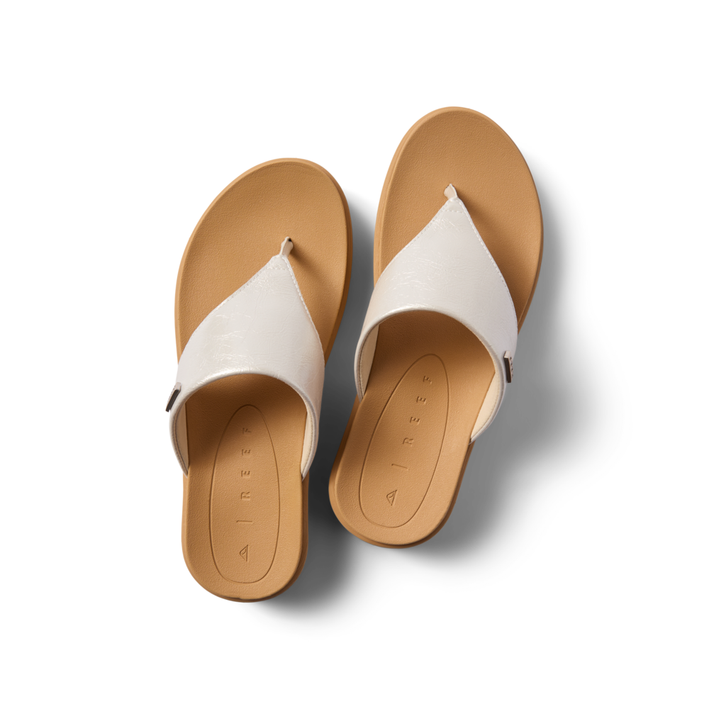 Aura Serenity women's white sandals top view showing toe post and cushioned footbed facing upward with comfort features.