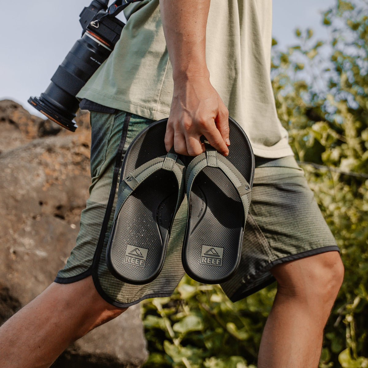 Cushion Phantom 2.0 men's flip flops held by hand, showing top view with anatomical arch support and cushioning