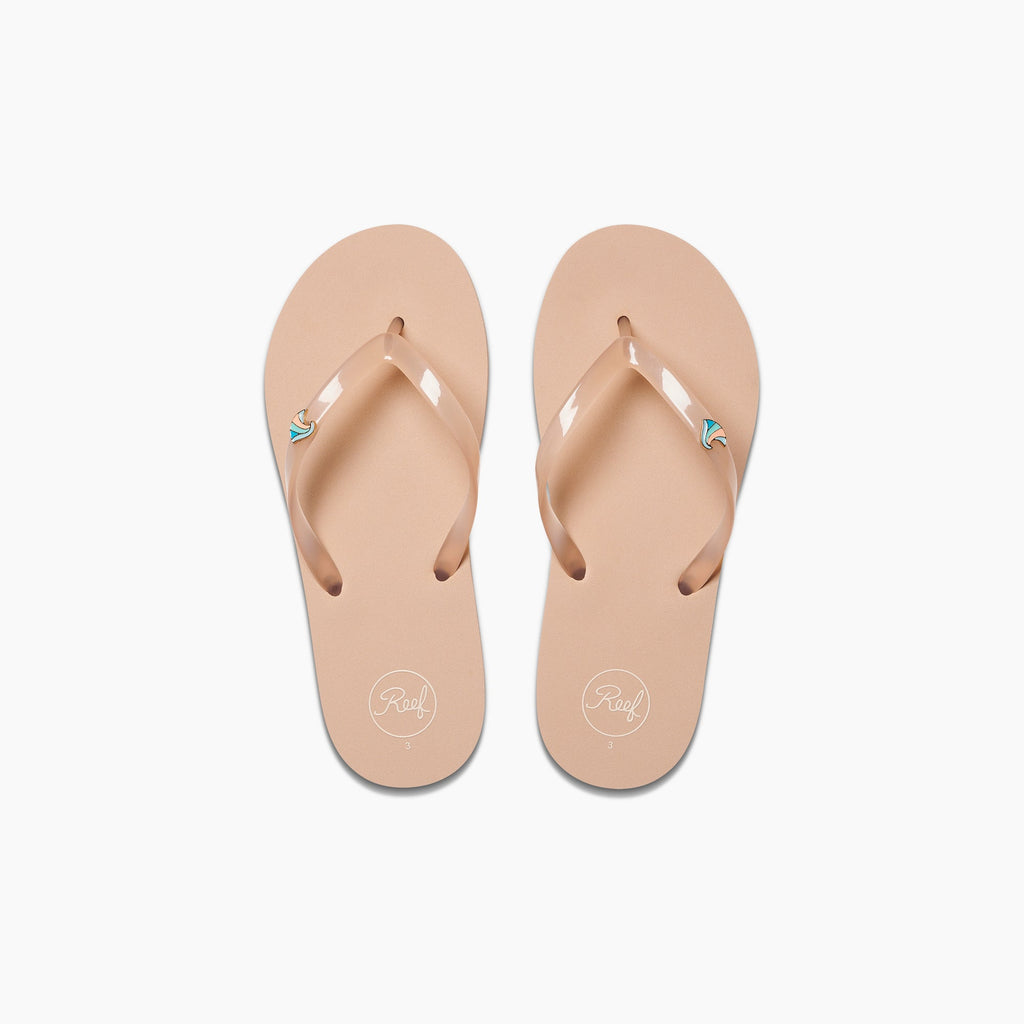 Kids Charming beige flip flops for girls, top view showing toe straps with reef logo, beach inspired comfort sandals.