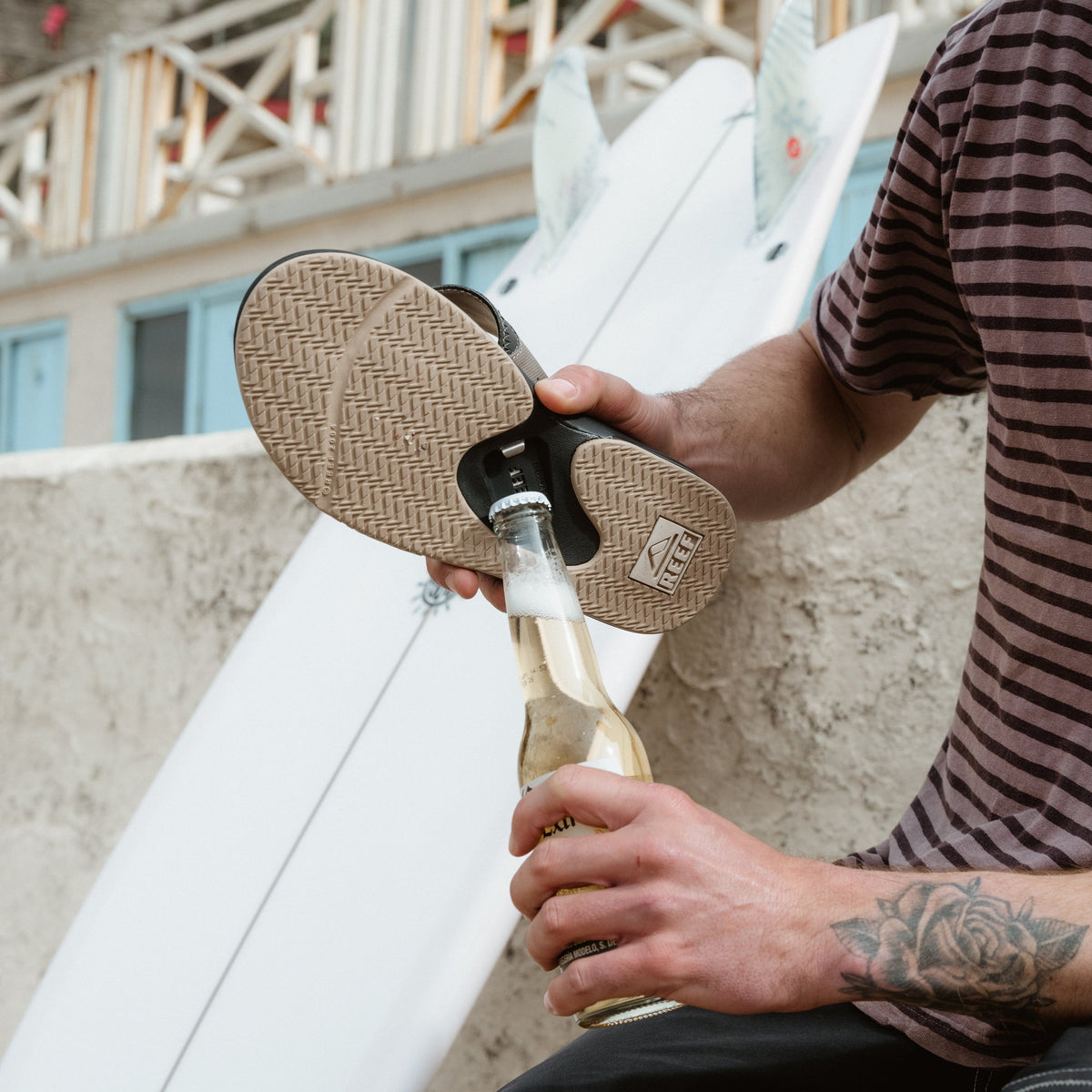 Fanning men's sandal showing sole facing upward with bottle opener feature, highlighting comfort and surf-inspired design