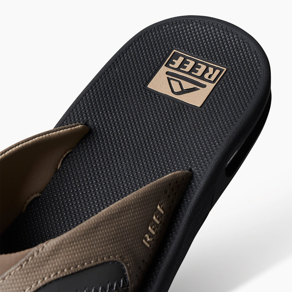 Fanning men's right sandal facing up showing textured footbed with anatomical arch support and cushioned strap