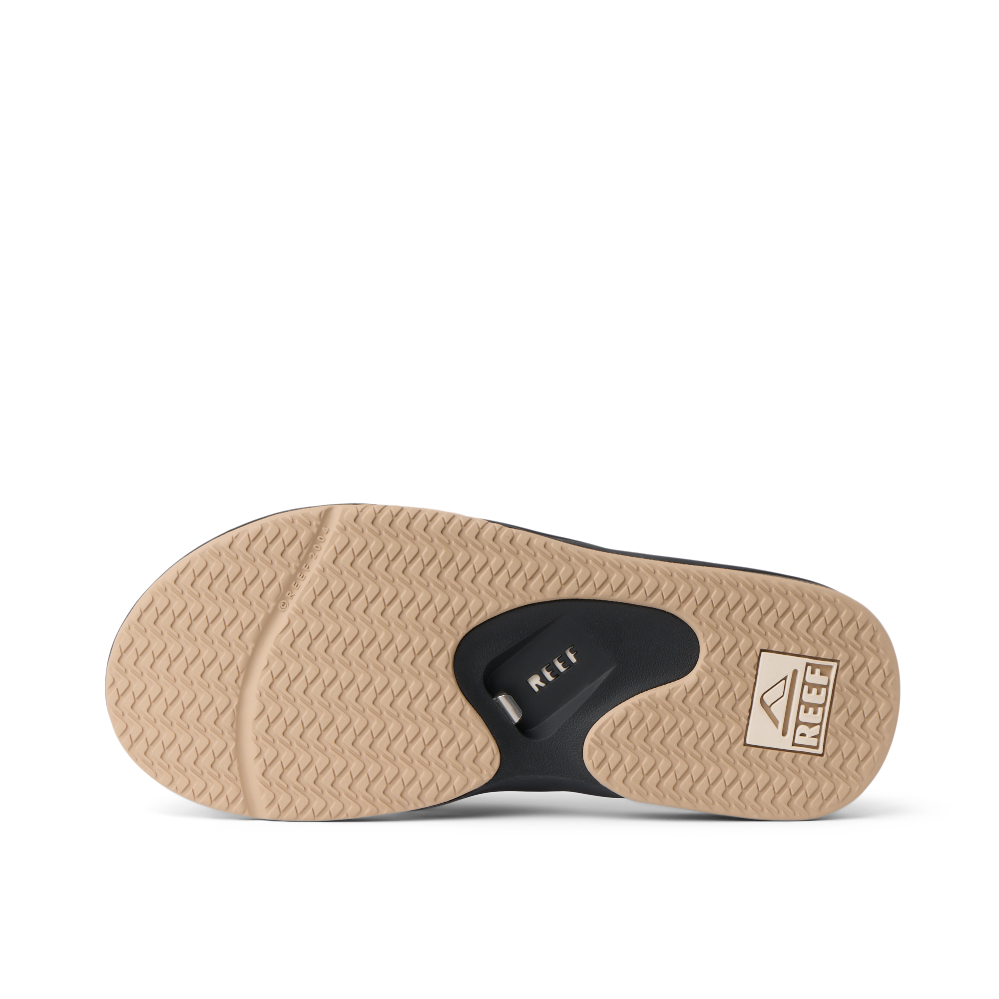Fanning men's flip flop outsole facing up, brown herringbone tread with black bottle opener and REEF logo for beach comfort