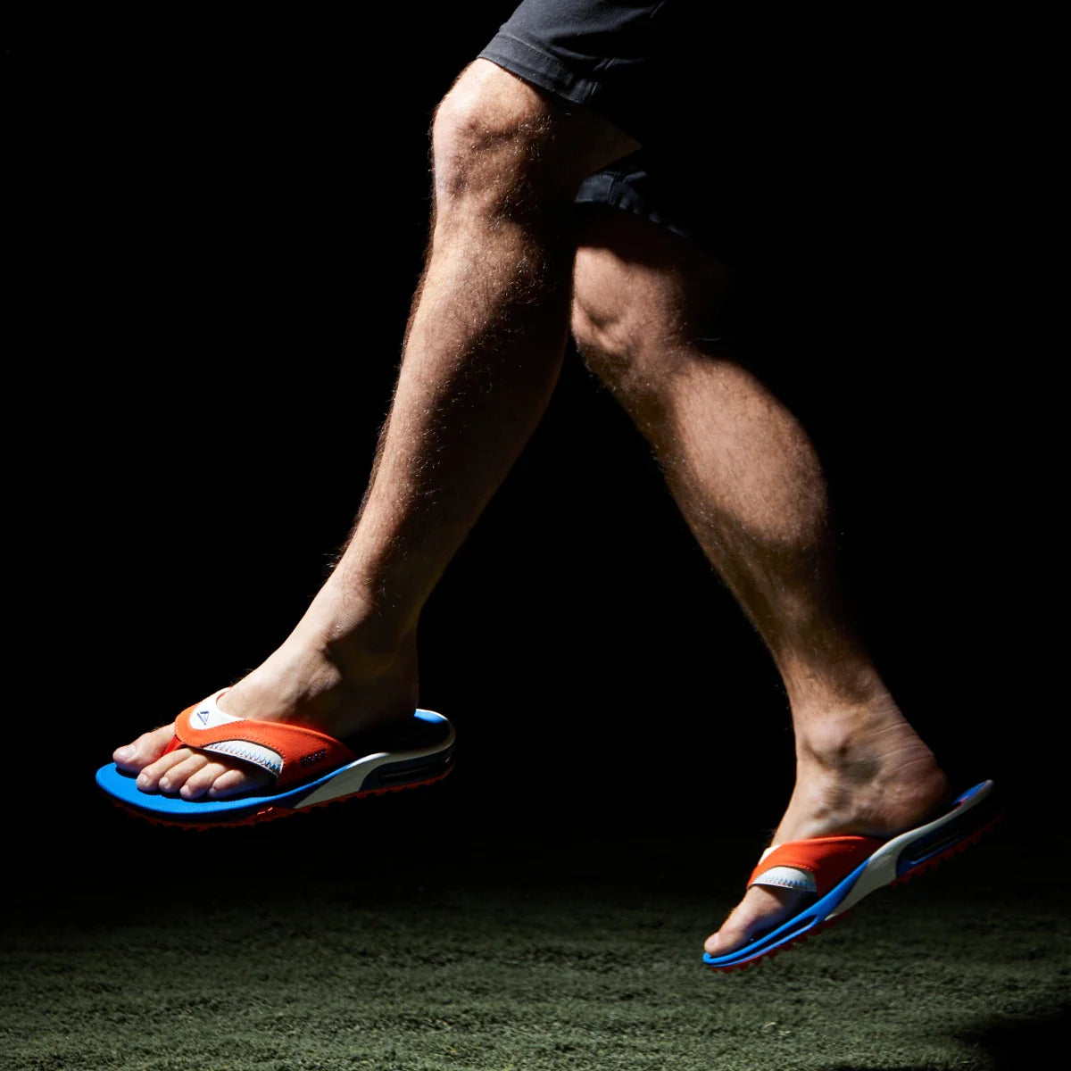 Fanning Pregame men's sandals facing right, showing side and top views with orange and blue comfort design.