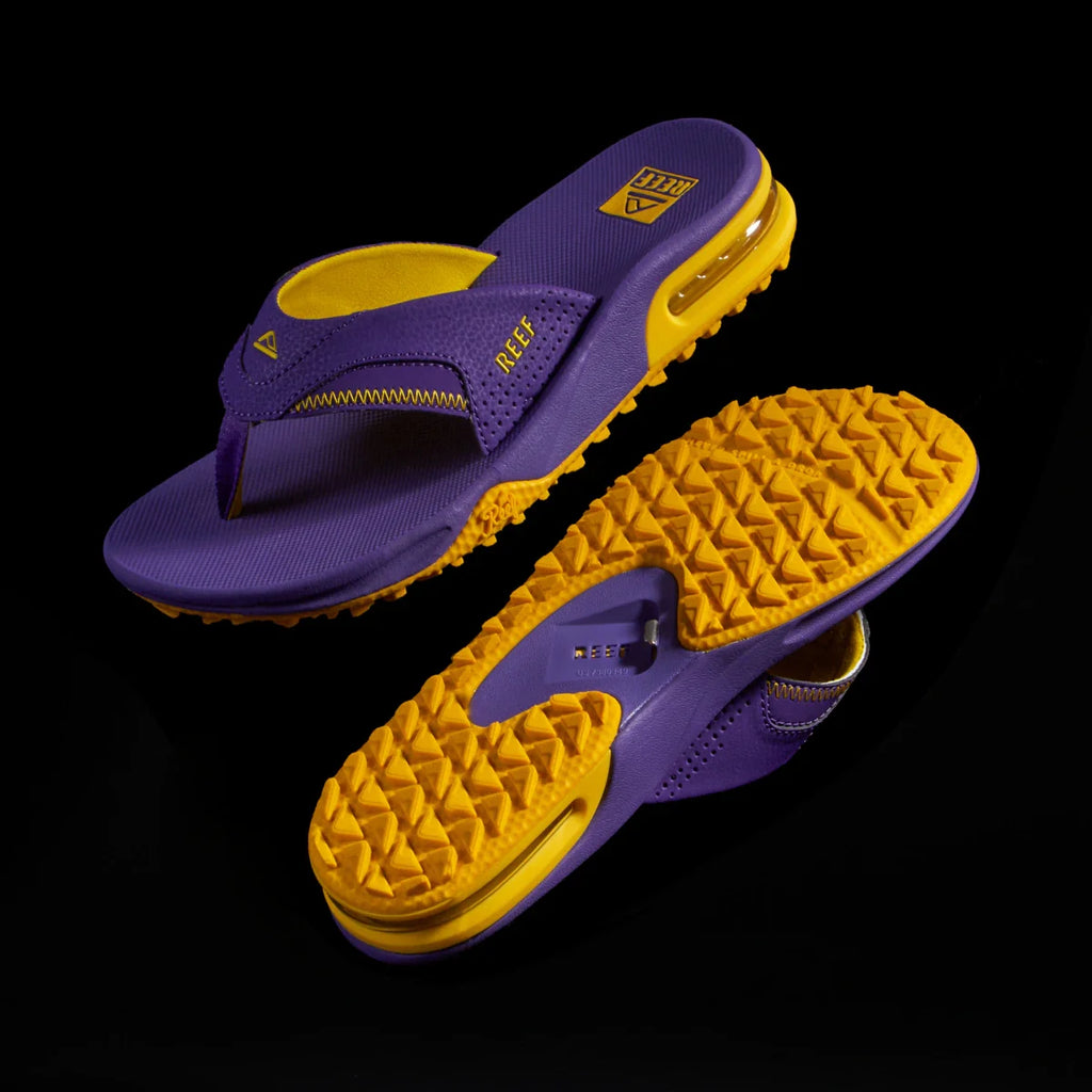 Fanning Pregame men's purple and gold sandal showing top view and bottom tread facing left, surf-inspired comfort design.