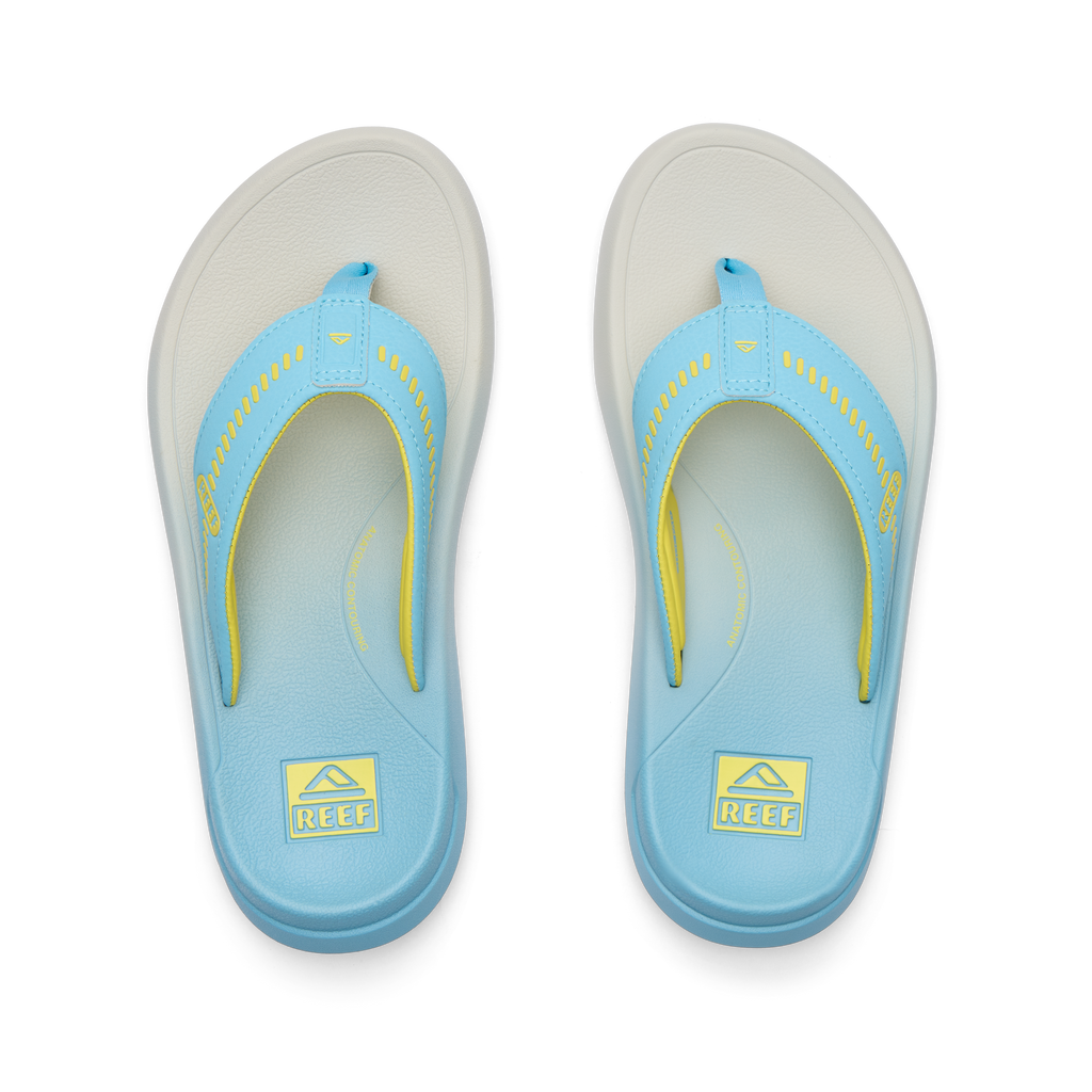 Top-down view of blue and yellow Cruiser sandals for men with anatomical arch support and soft cushioning for beach comfort.