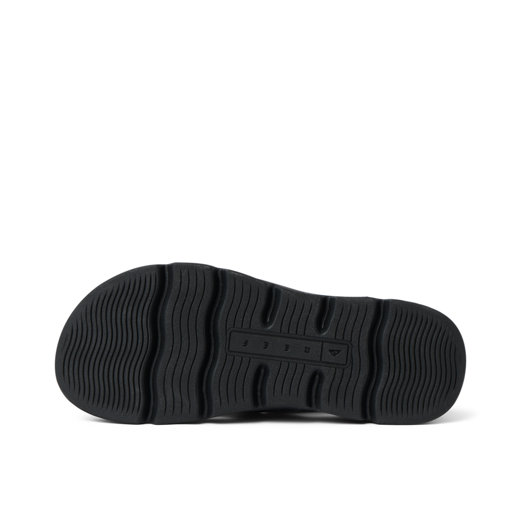 Vista Luxe Sierra black shoe sole facing up, showing wave-patterned tread with REEF logo and comfort-focused design.