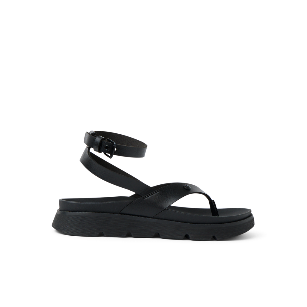 Vista Luxe Sierra black sandal facing left, showing side view with ankle strap, platform sole, and cushioned footbed.
