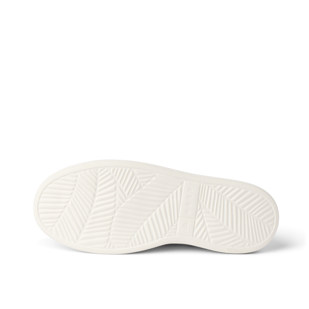 Reef Neptune adult women's shoe outsole facing up, showing durable, water-friendly sole with beach-inspired pattern.