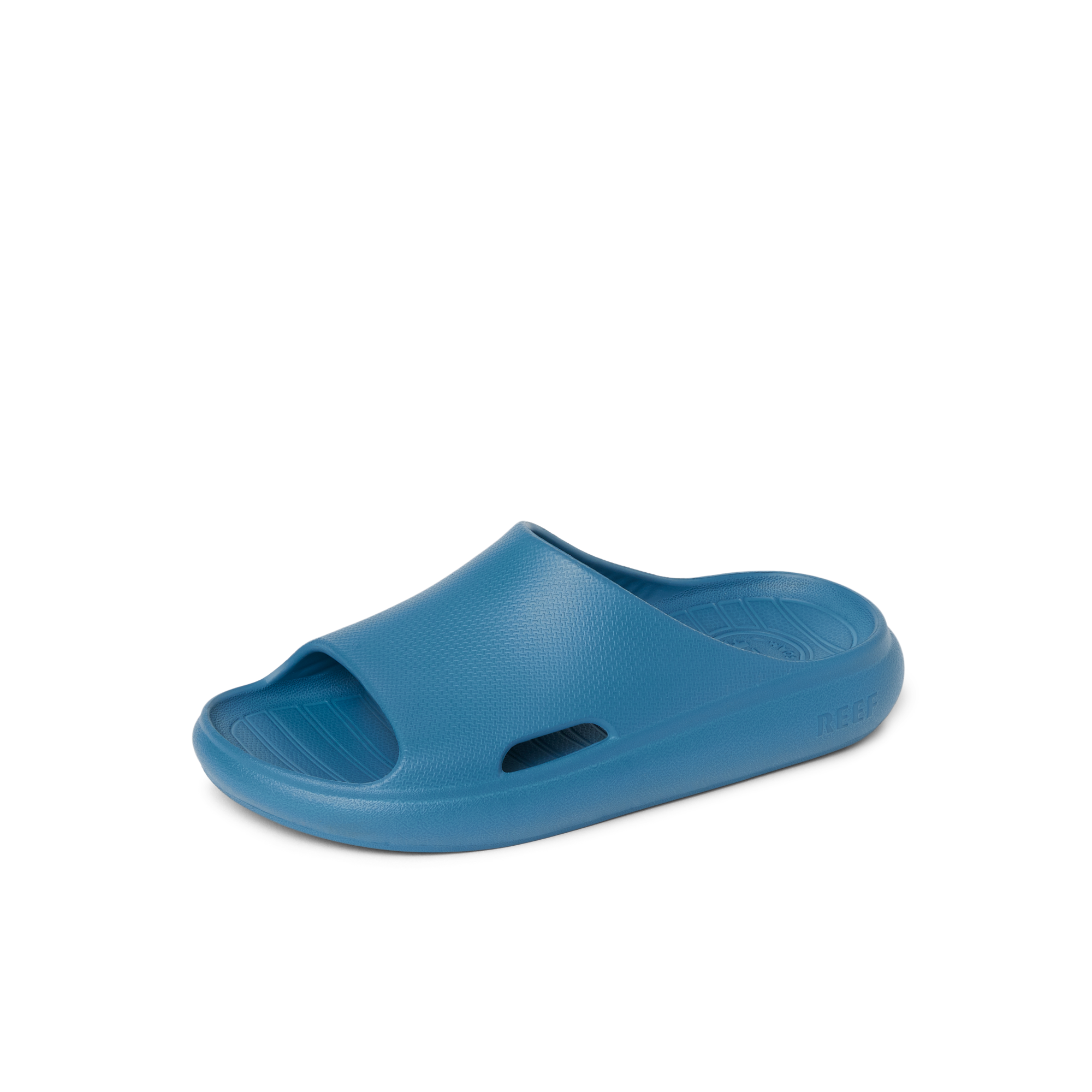 Kids Rio Slide in blue, right-facing, close-up of top and side, featuring soft cushioning and water-friendly design.