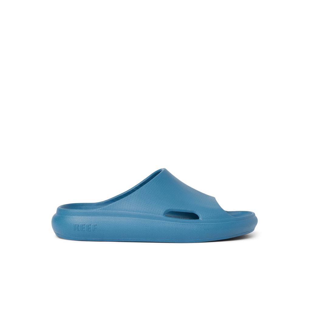 Kids Rio Slide in navy facing right, close-up side view, showcasing water-friendly, cushioned beach footwear for kids.