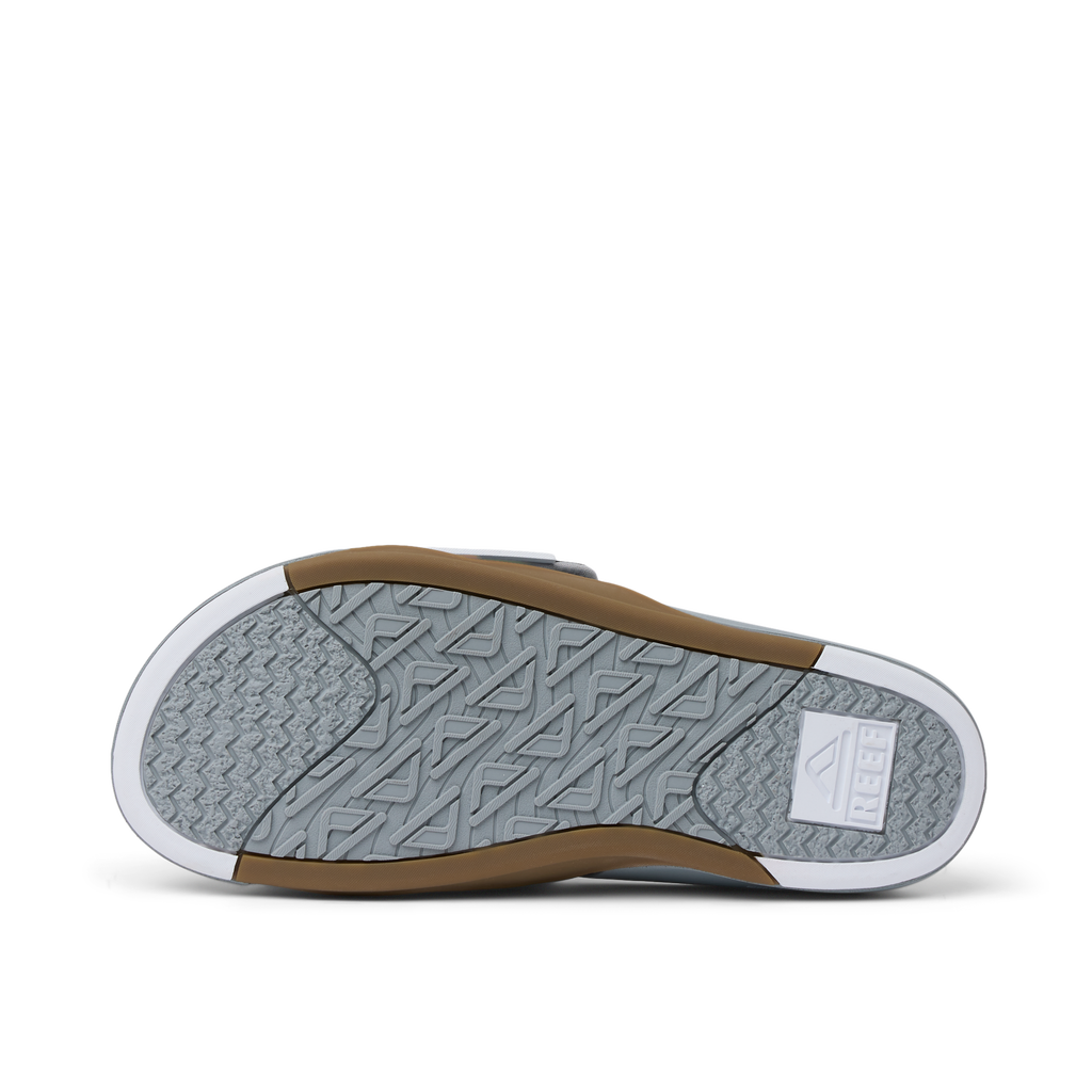 Phantom Slab men's footwear sole facing up showing durable water-friendly rubber tread with REEF logo and arch support design