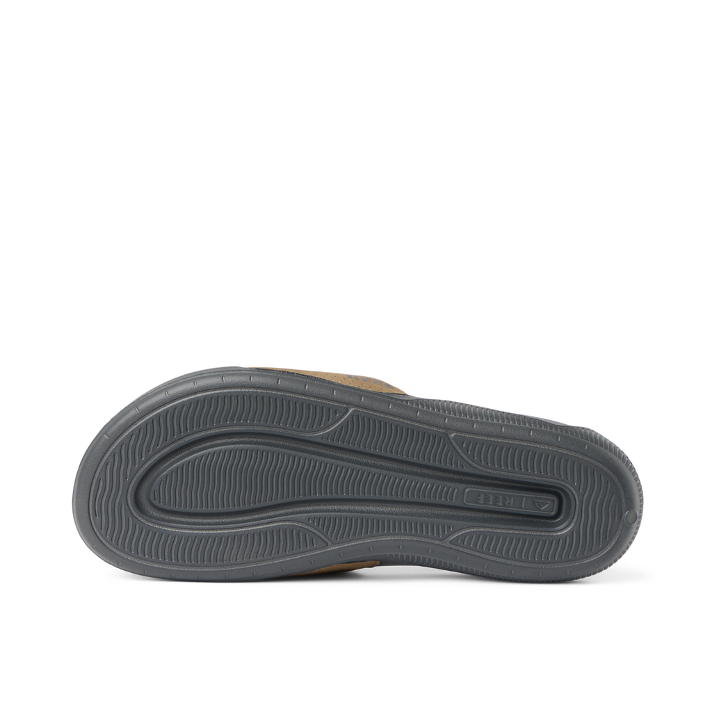 Tailslide men's sandal sole facing up, showing durable, water-friendly outsole with anatomical arch support and cushioning.