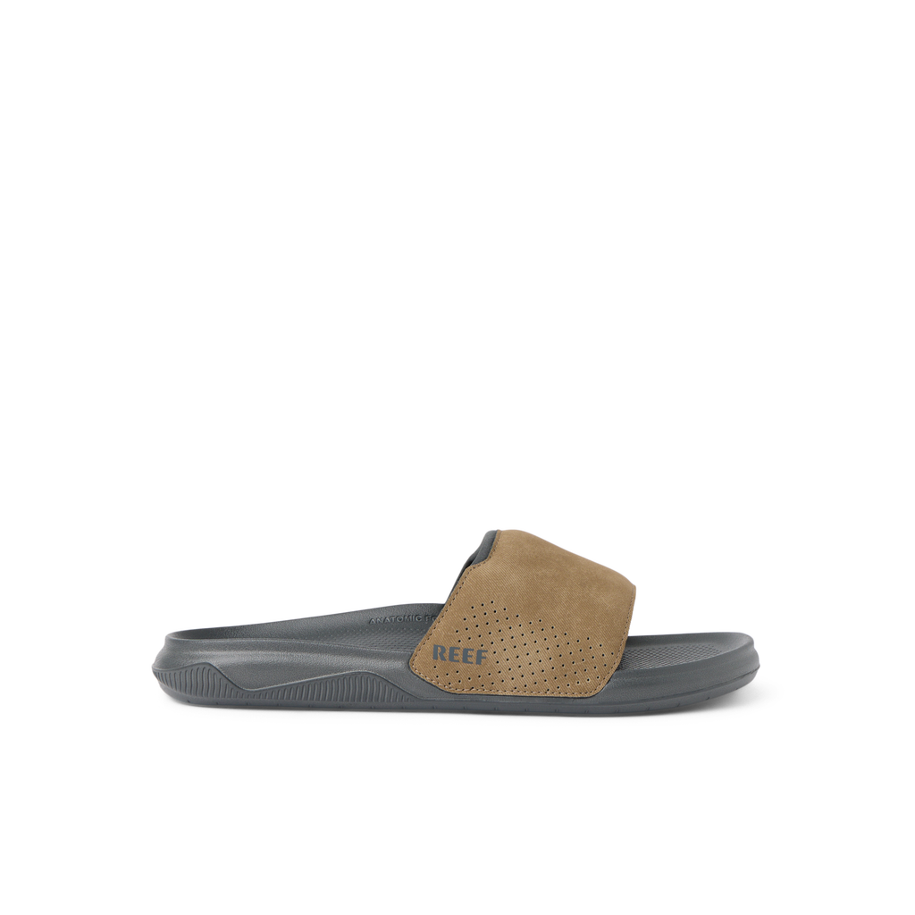 Tailslide slide sandal facing left, showing tan perforated strap and soft-rebound cushioned sole for comfort and durability.