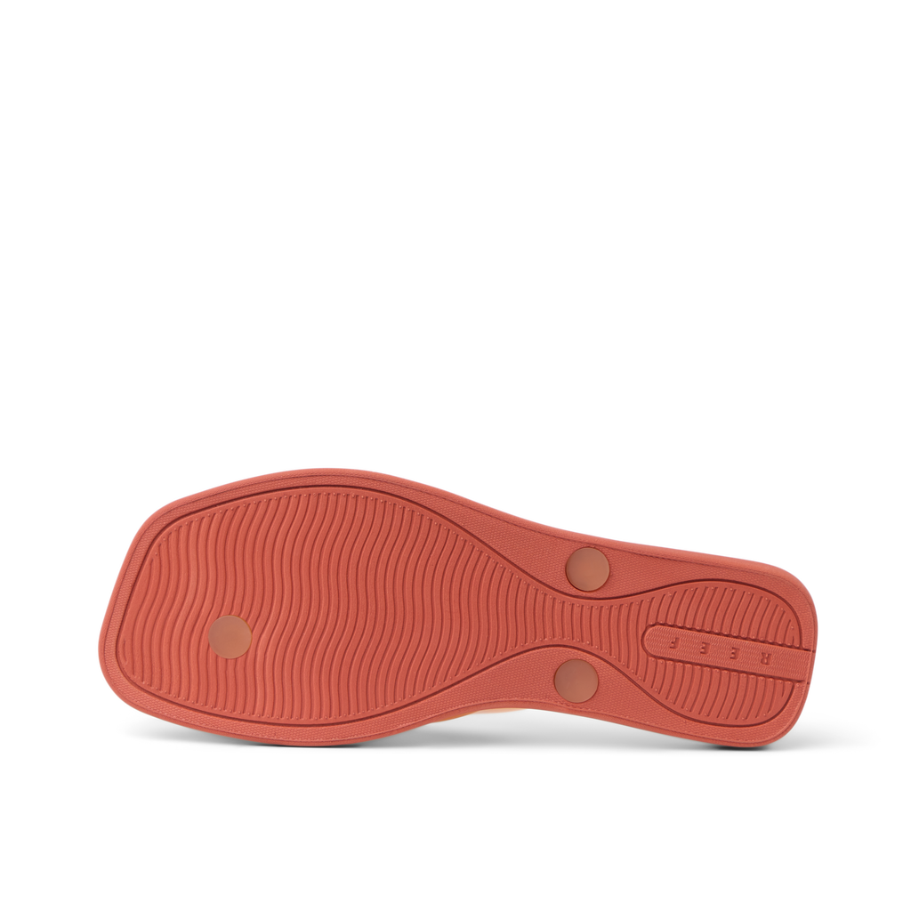 Solaye women's orange outsole facing up, showing textured grip with beach-inspired comfort and durability features.