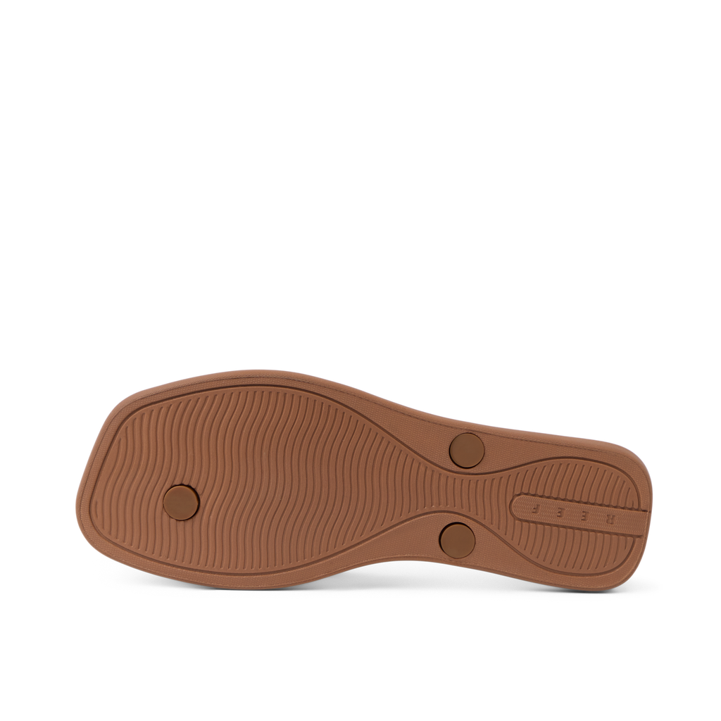Solaye women's footwear showing the outsole facing up, highlighting durable, water-friendly sole with REEF branding.