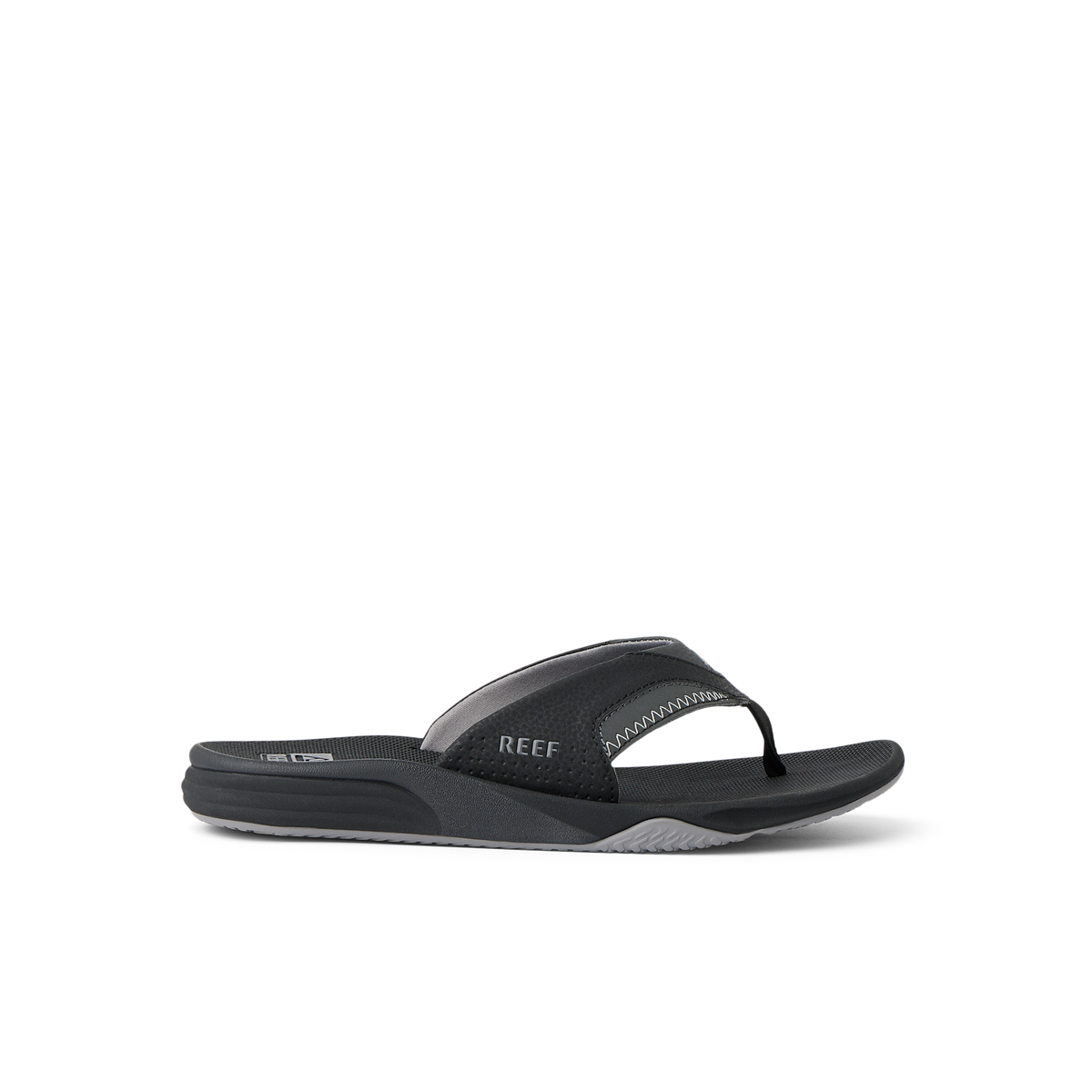Cushion Fanning black flip flop sandal facing right with arch support and soft cushioning, designed for beach comfort.