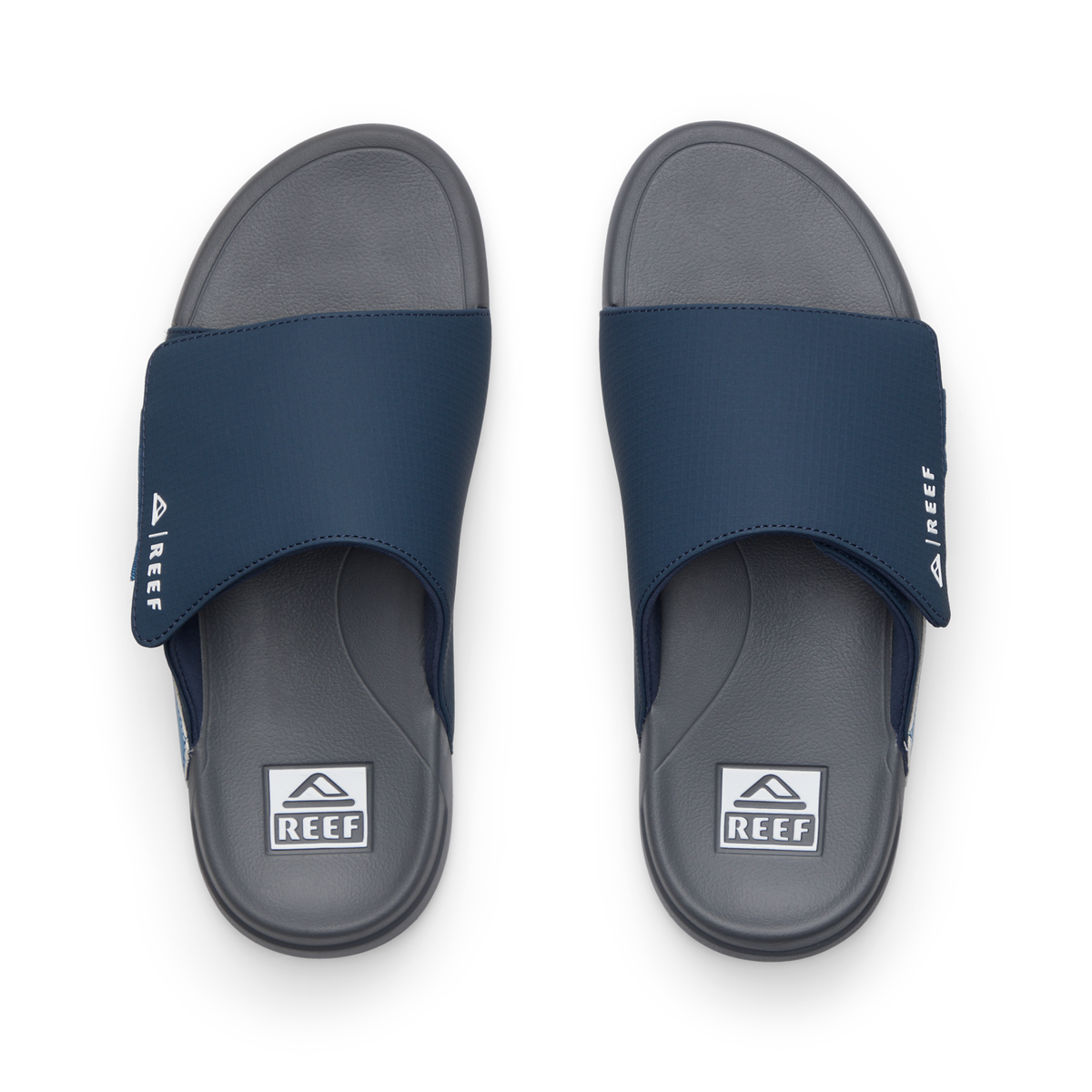 Top view of men's Cruiser Slide navy and grey slides with anatomical arch support and soft cushioning by REEF.