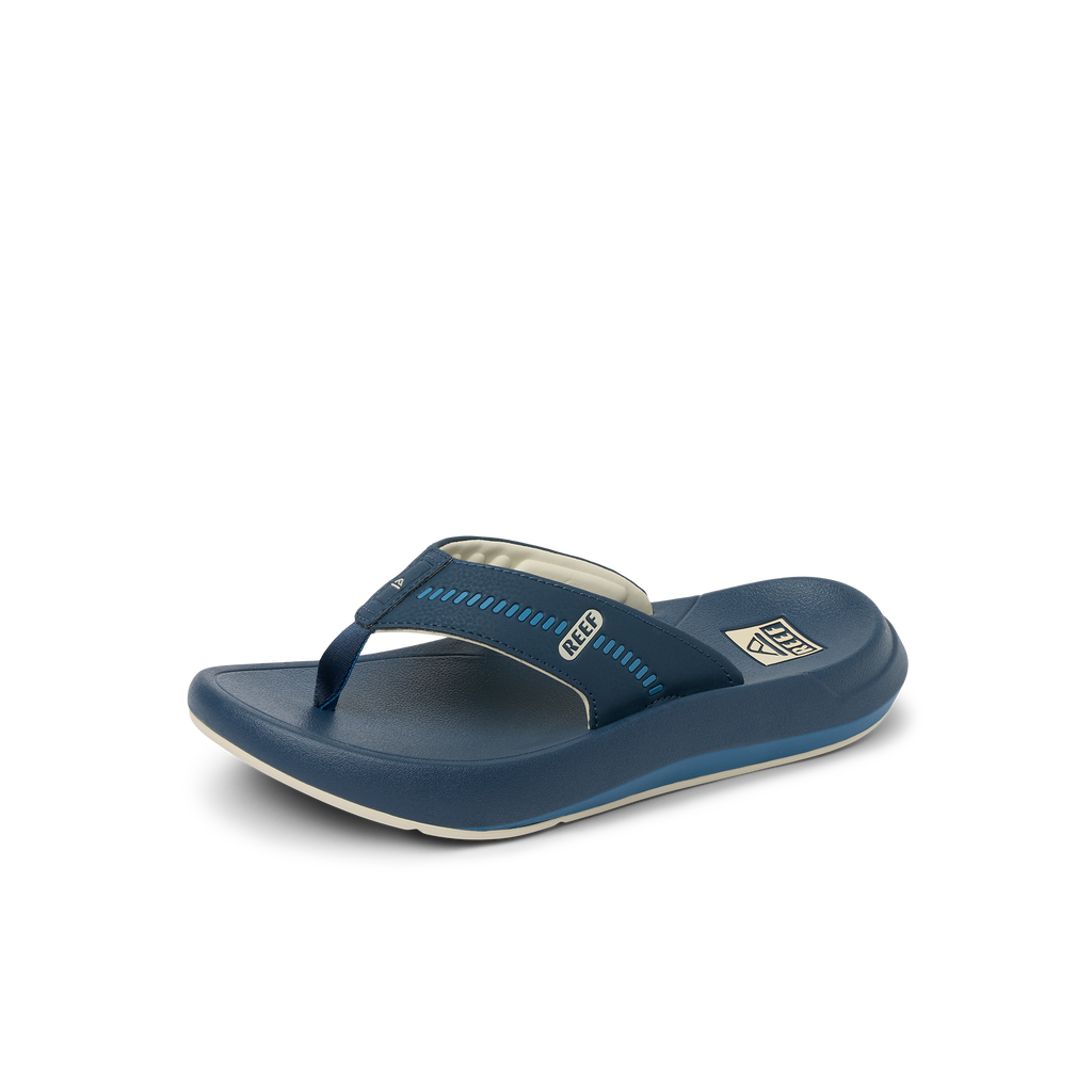 Cruiser men's navy blue flip flop facing right, showing top and side, with cushioned footbed for beach comfort.