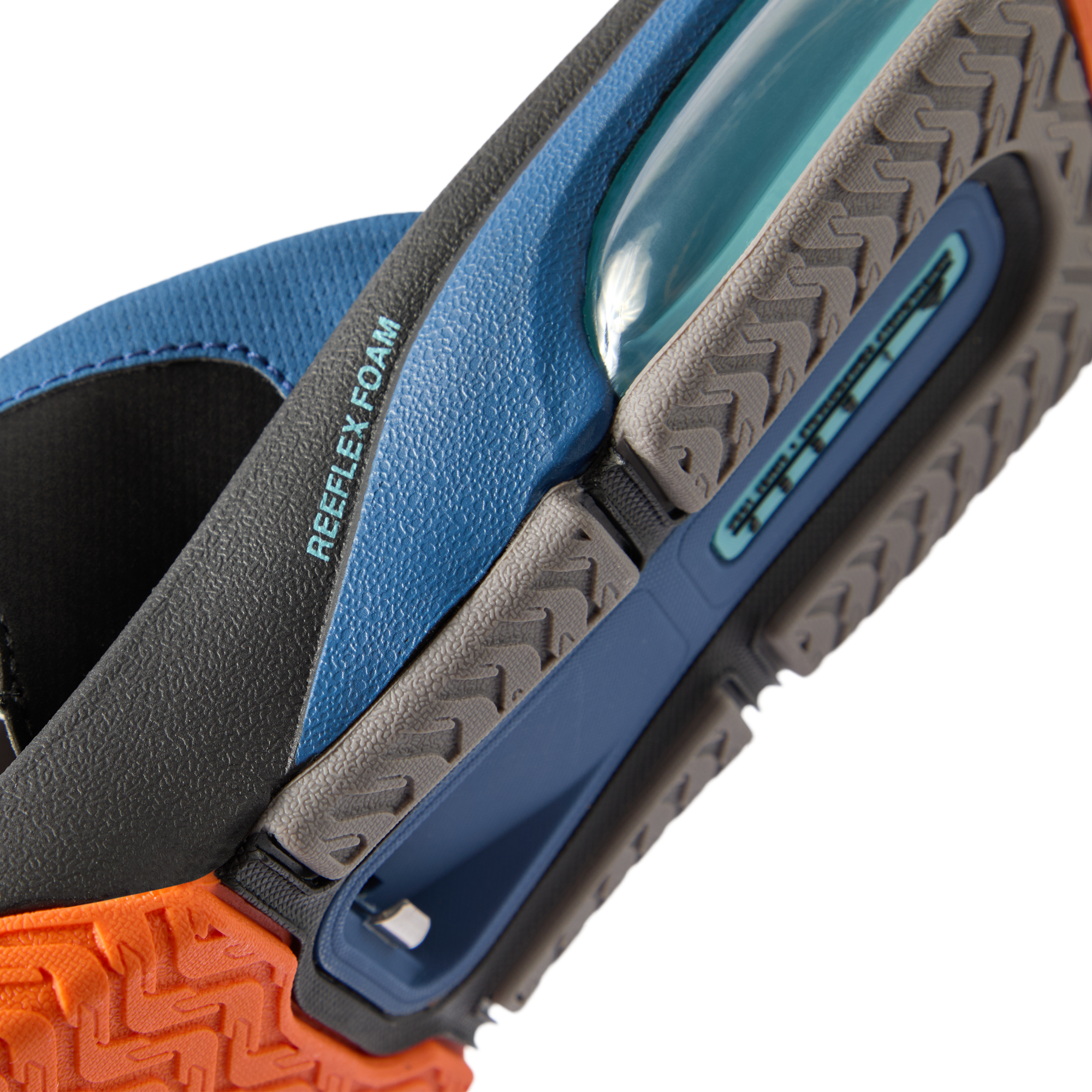 Close-up of the bottom sole and heel of the Fanning + men's shoe featuring Reefflex Foam cushioning in blue, black, and orange.