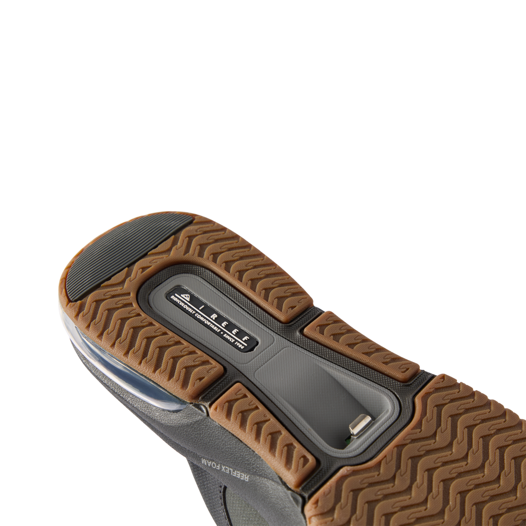 Fanning + men's footwear showing the black gum outsole with textured tread facing upward, surf-inspired comfort design.